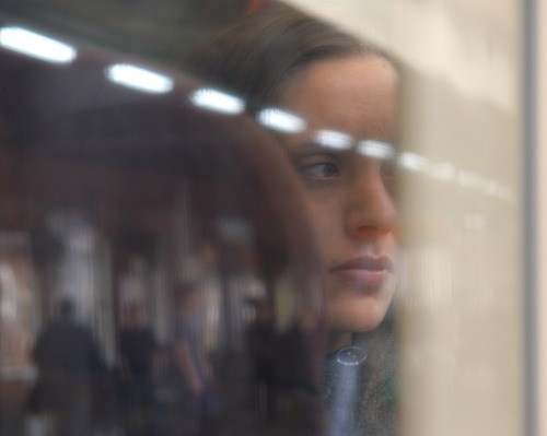 Beautiful woman reflected in train window