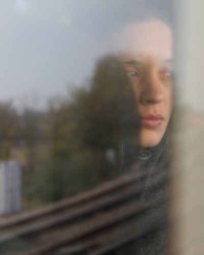 Beautiful woman reflected in train window