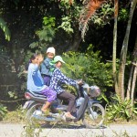 Kid standing on moped in Chiang Mai, Thailand